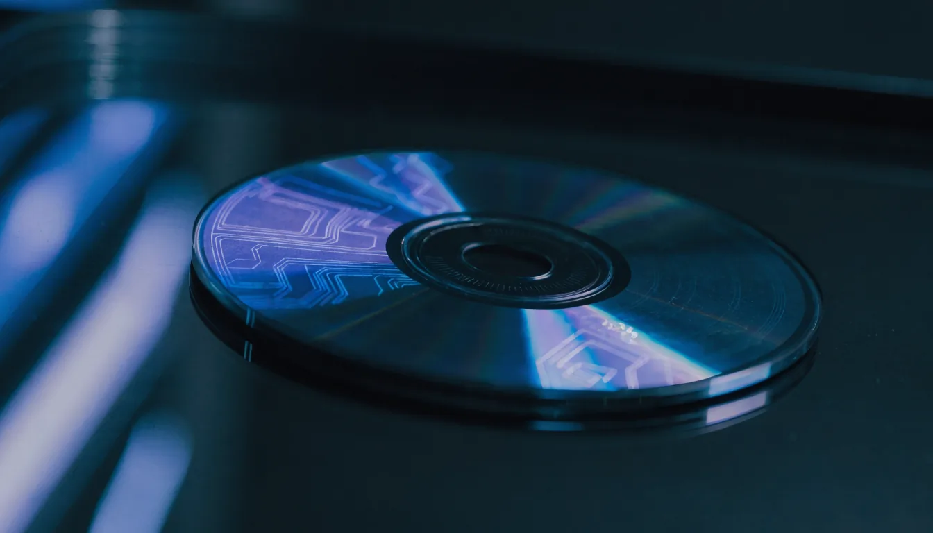 A physical game disc with a glowing holographic NFT token overlay on a dark reflective surface